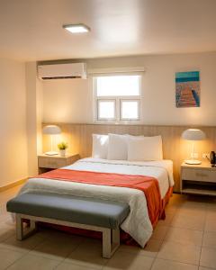 a bedroom with a large bed and two lamps at Hotel Vista Bahia & Marina in Salinas +21 photos