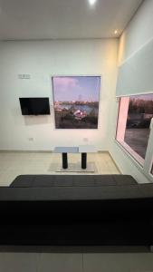 a room with a large picture on the wall at ALTOS DEL MIRADOR b in Patagones