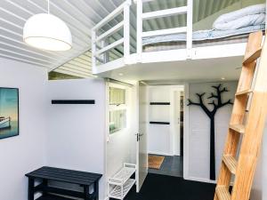 a room with a bunk bed and a staircase at 5 person holiday home on a holiday park in Karrebæksminde in Karrebæksminde