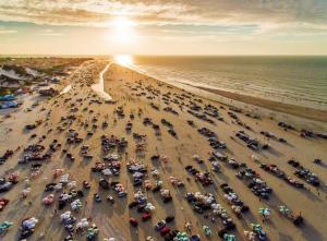 an aerial view of a beach with many parked cars at Apt Salinas Premium Resort - 1007 in Salinópolis