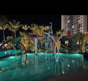 a pool with a water slide in a city at night at Apt Salinas Premium Resort - 1007 in Salinópolis +3 photos