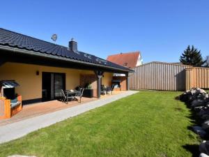 a house with a deck and a yard at Seemöwe XL in Barnekow