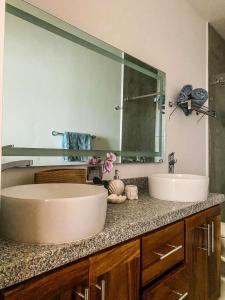 a bathroom with two sinks and a large mirror at Beautiful Celeste Condominium in La Paz +14 photos