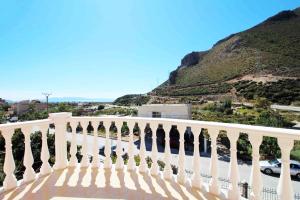 a white railing on a balcony with a mountain at Vila Romeo in Borsh