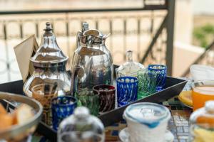a group of glass cups and bottles on a table at Riad Dar Kenza in Fès +48 photos