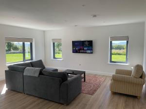 a living room with a couch and a chair at Rolling Hills in Westport