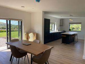 a dining room and kitchen with a table and chairs at Rolling Hills in Westport