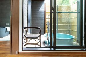 a bathroom with a chair and a tub outside at 谷町君 星屋 神泉ノ宿 二条城 in Kyoto