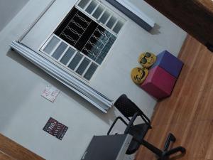 an overhead view of a room with a chair and a window at Sítio Rodrigues in Pedro Leopoldo