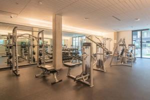a gym with rows of treadmills and machines at Relaxing 1BD - Pool, Gym, Parking, W-D - Sleeps 4 in Tempe