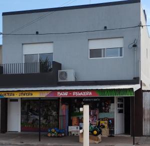a store front of a building with a balcony at Arequito centro in Arequito