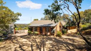 an old brick house in the middle of a yard at HeartStone Hill - Studio in Castlemaine