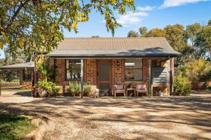 a brick house with a dog sitting in front of it at HeartStone Hill - Studio in Castlemaine +17 photos