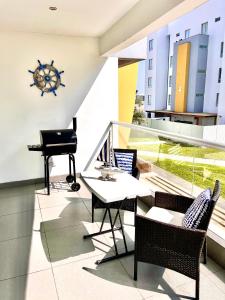 a balcony with a table and a piano on a building at Paracas Paracas! Vista Bahia - Sotavento 201 T 6 in Paracas