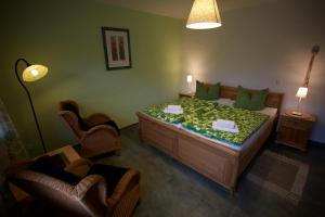 a bedroom with a large bed with green walls at Gästehaus Bohg in Burg
