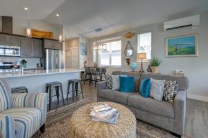 a living room and kitchen with a couch and a table at Whispering Waves Cottage in Ocean Shores