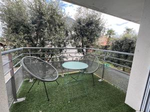 a table and two chairs on a balcony at Appartement Nature au calme in Albi