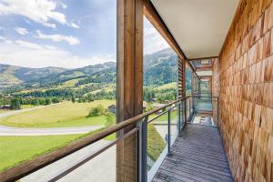 a balcony with a view of the mountains at Kempinski Hotel Das Tirol in Jochberg