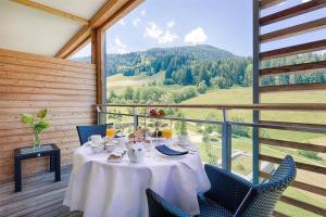 a table in a room with a view of a mountain at Kempinski Hotel Das Tirol in Jochberg