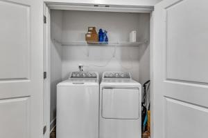 a kitchen with two white appliances in a room at Luxurious King 2BR Suite Mins to Downtown Durham! in Durham
