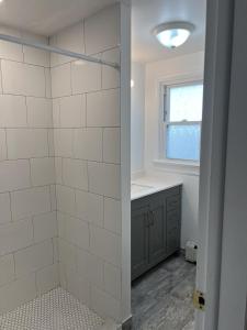 a bathroom with a shower and a sink at Beautiful Bradley Beach Views, Unbeatable Dream Porch, New Grill, 6 Badges in Bradley Beach