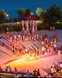 a crowd of people standing around a stage at night at Premier Fort Beach Sveti Vlas in Sveti Vlas +23 photos