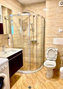 a bathroom with a shower and a toilet and a sink at Premier Fort Beach Sveti Vlas in Sveti Vlas