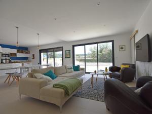 a living room with a couch and a table at Holiday Home Beaufort with Private Pool in Beaufort