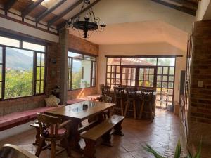 ein Esszimmer mit Tisch und Stühlen und Fenstern in der Unterkunft Casa Finca Los Arrayanes, spectacular views! in Villa de Leyva + 35 Fotos