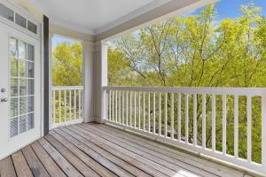 a room with a balcony with a view of trees at Upscale King 2BR Suite Mins to Downtown Raleigh! in Cary