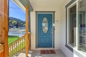 a blue door on a house with a porch at The Gather House in The Dalles
