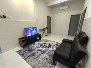 a living room with a couch and a television at RumaHomestay in Pekan
