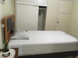 a bedroom with a bed with a white bedspread at Rubi 2 in Los Ángeles