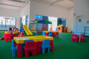 a childrens play room with a table and colorful chairs at Lacqua diroma I - II - III - IV - V - CN M in Caldas Novas +21 photos