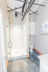 a bathroom with a shower and a toilet at The Secret Cenote Hotel in Jacksonville