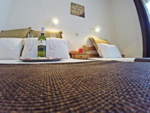 a room with a bottle of wine on a bed at Studios Filippina in Skala Potamias +10 photos