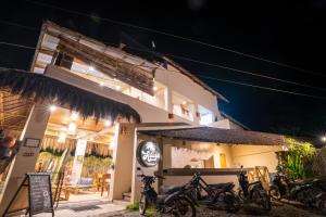 a building with bikes parked outside of it at night at New Private Rooms in Haole Santa Fe in General Luna