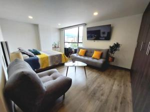 a living room with a bed and a couch at Acogedor y central Apartamento ! in Pasto