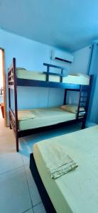 a room with two bunk beds and a blue ceiling at Russ Apartment 2 Diagonal comando in San Andrés