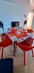 a red table with two red chairs and a red table and chairs at Russ Apartment 2 Diagonal comando in San Andrés