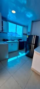 an empty kitchen with blue lights in a kitchen at Russ Apartment 2 Diagonal comando in San Andrés
