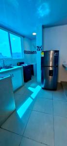 a kitchen with a refrigerator with blue lights in it at Russ Apartment 2 Diagonal comando in San Andrés +12 photos