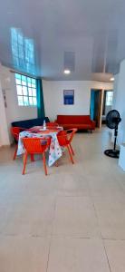 a room with a table and chairs and a couch at Russ Apartment 2 Diagonal comando in San Andrés