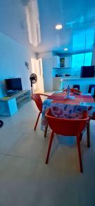 a living room with a red table in a room at Russ Apartment 2 Diagonal comando in San Andrés