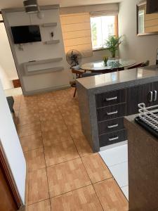 a kitchen with a counter top and a wooden floor at Apart Marchelo 2 in San Antonio +3 photos