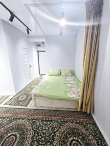 a small bedroom with a bed in a room at Chilanzar Apartment for 5 persons 5 beds, kitchen, Bathroom, toilet, Wifi, TV, washing machine in Chilanzar