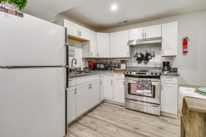 a kitchen with white cabinets and a refrigerator at Cozy Studio Retreat in Salt Lake City Area! in Magna