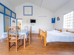 a room with a table and a bed and a table and chairs at Maison de vacances à Lit-et-Mixe pour 4 pers. - Calme et nature avec jardin inclus - FR-1-50-176 in Lit-et-Mixe +10 photos