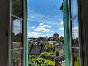 an open window with a view of a city at Maison Rénovée avec Jardin et WIFI à La Roche-Posay - FR-1-541-173 in La Roche-Posay +14 photos