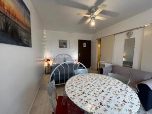 a living room with a table and a couch at Studio en centre-ville avec WIFI, proche thermes - FR-1-541-174 in La Roche-Posay +1 photo